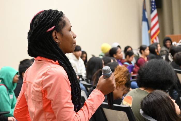 A student asking a question to a panel at the culminating event at Cargill HQ in Wayzata.