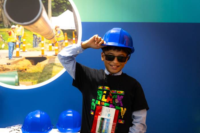 A photo of a student in a hardhat working at the CenterPoint Energy shop.